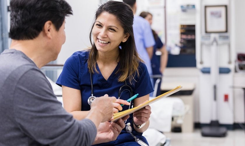 Nurse seated with patient