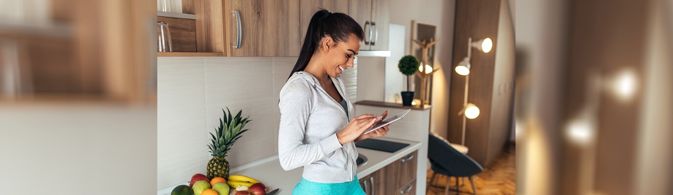 Woman on her phone in kitchen