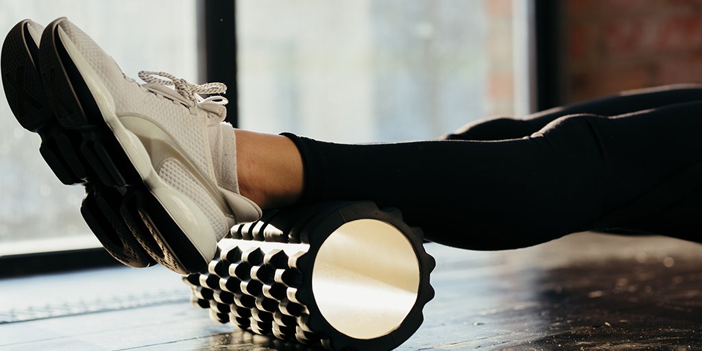 Woman foam rolling leg